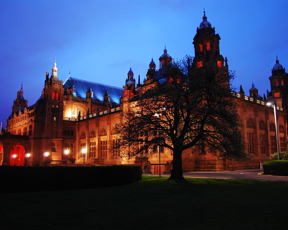 Kelvingrove Art Gallery and Museum lit up from the street at night